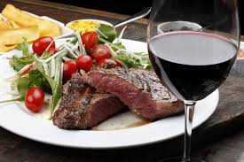 gourmet steak and goblet of wine cooking